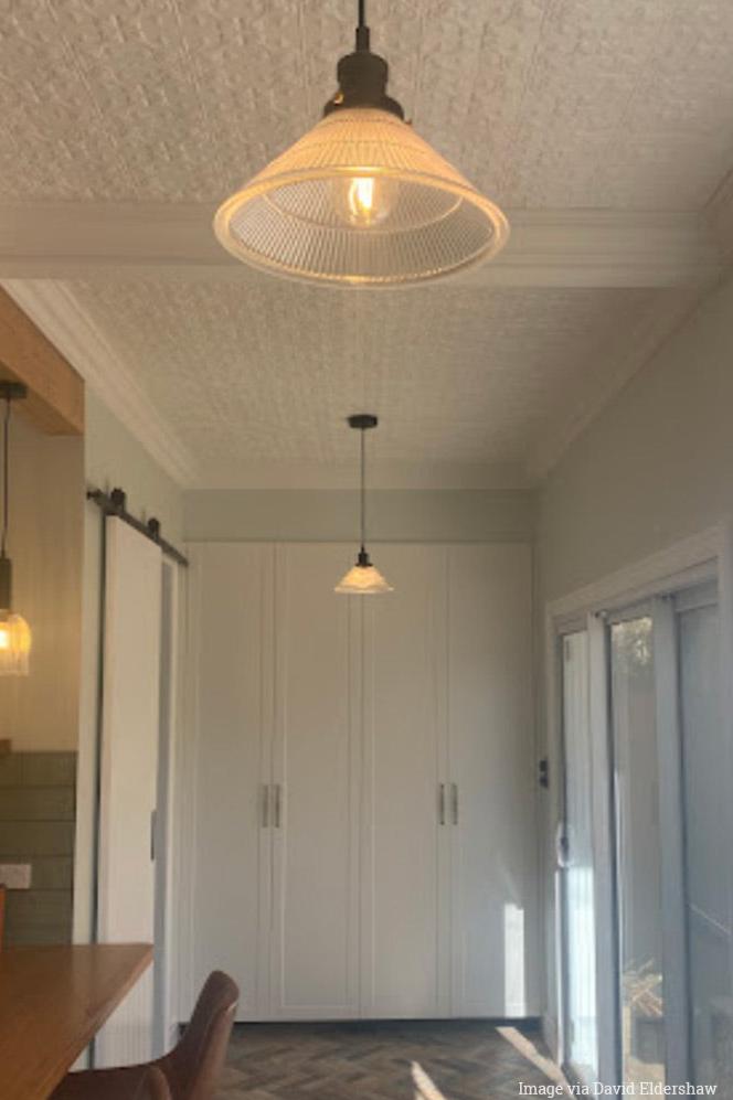 Image via David Eldershaw, 2 pleated pendants in a study.