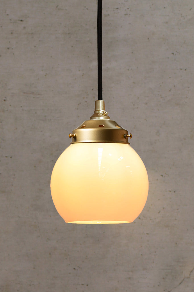 Small opal open glass ball shade on a gold/brass gallery and pendeant cord. 