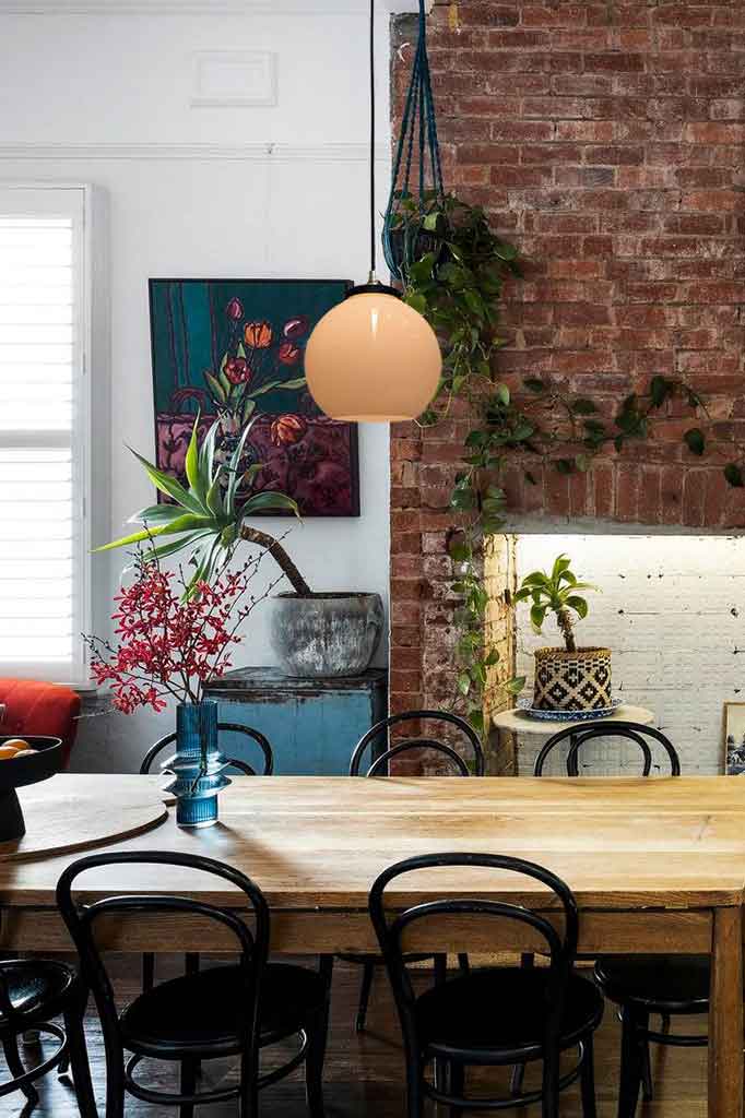 open glass pendant with round black cord over dining table