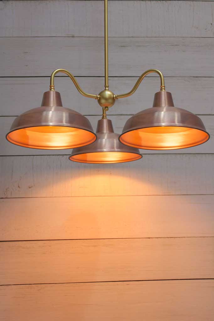 Industrial Gooseneck Chandelier with a gold fixture and copper shades. 