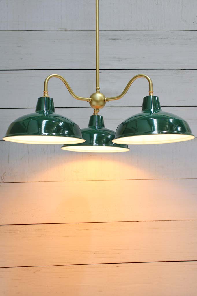 Gold brass gooseneck three arm fixture with federation green Warehouse shades. 