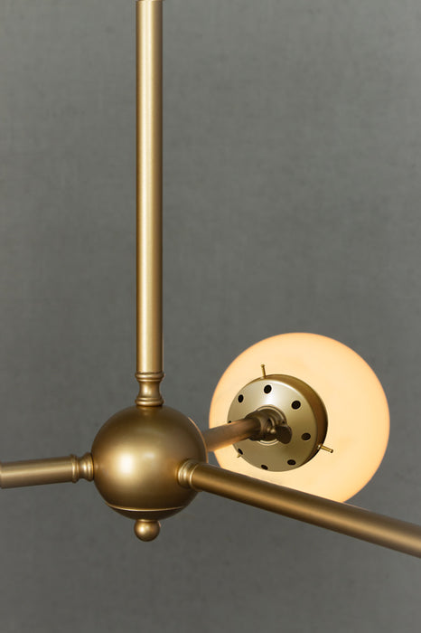 Close up of the Medium opal glass ball shades on the triple gold/brass chandelier. 