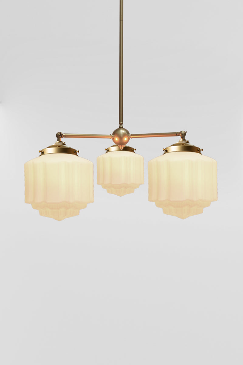 Triple sraight arm chandelier in gold/brass with three Deco shades.