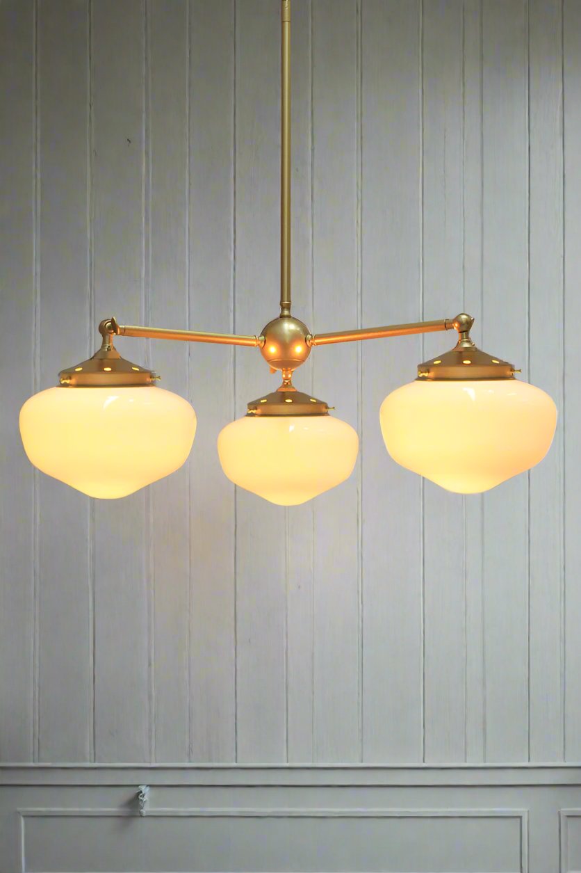 Gold/Brass 3 straight arm chandelier with small opal washington shades. 