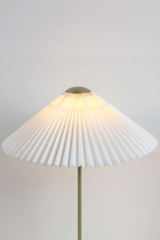 Close-up of the pleated lampshade of the table lamp