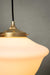 Close up of Chelsea schoolhouse shade on a gold gallery and black cord.