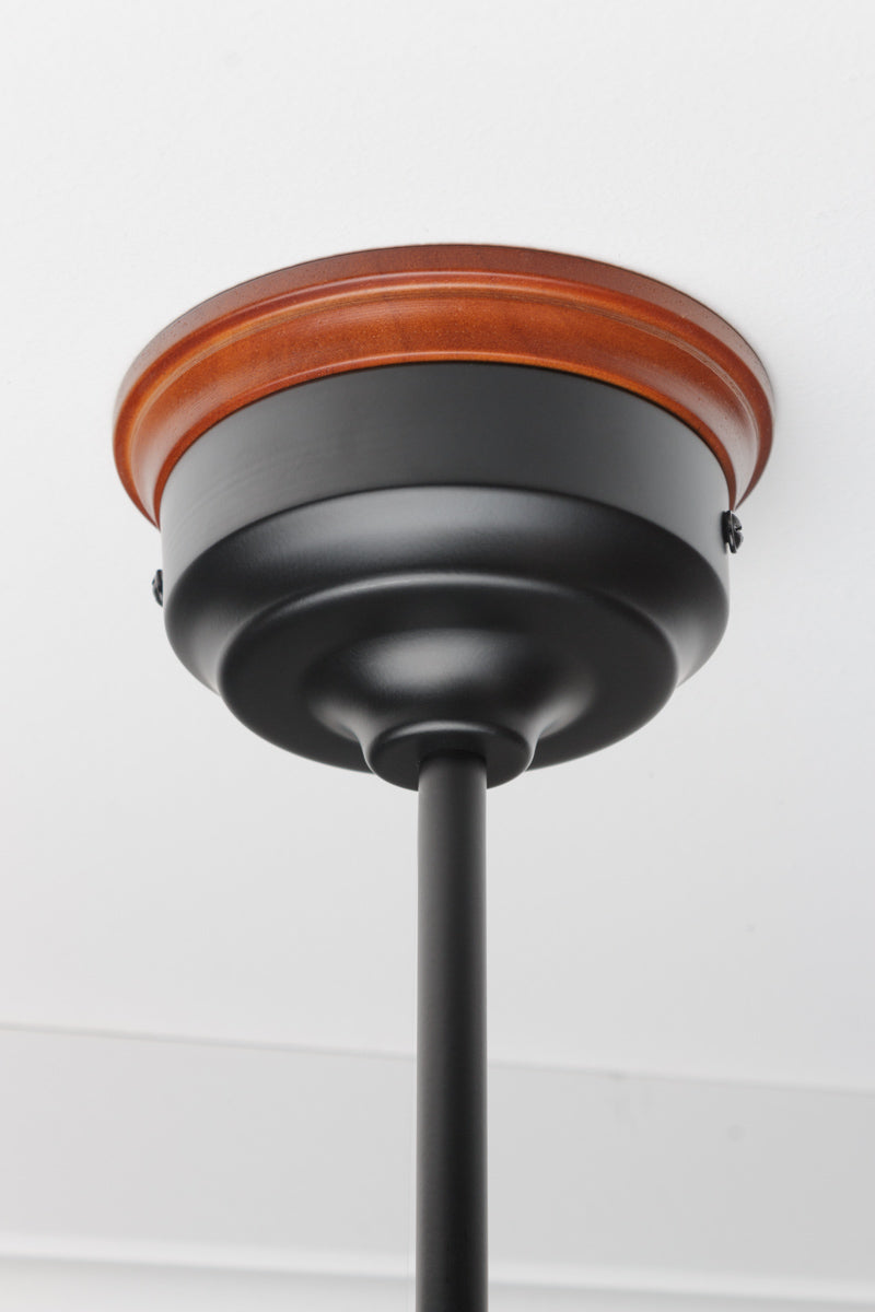 Black ceiling rose with rod intalled with a mounting block. 