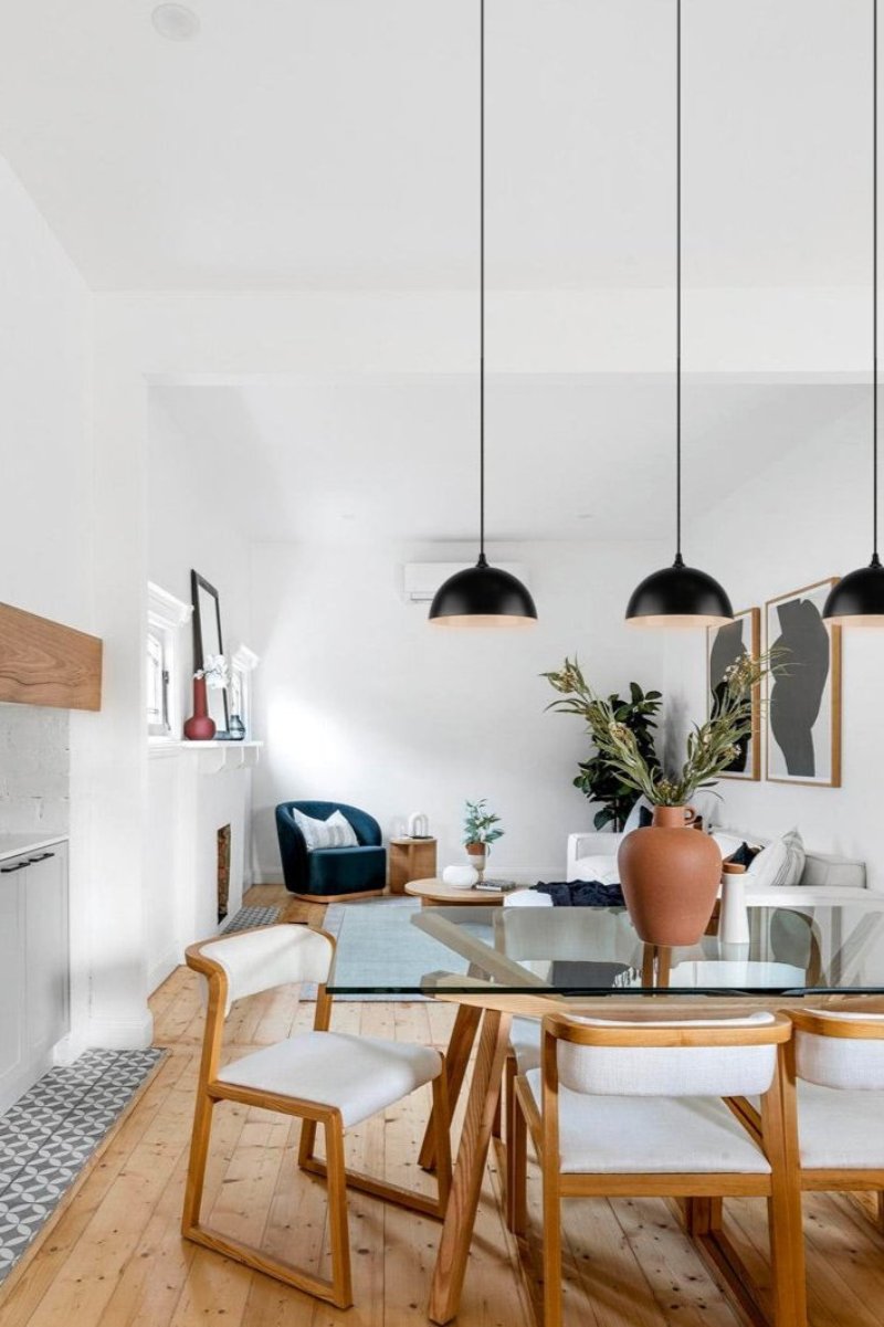 small black shades on black cords over dining table