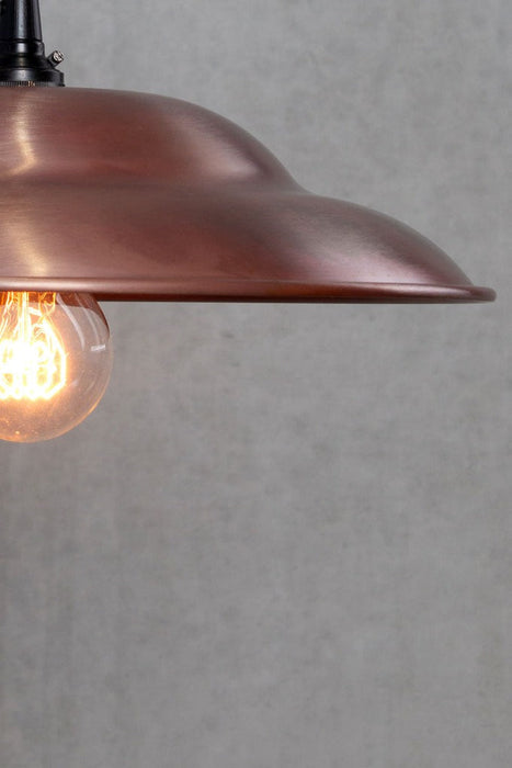 Close up of the Barn Wall Light with a copper shade and black  scone.