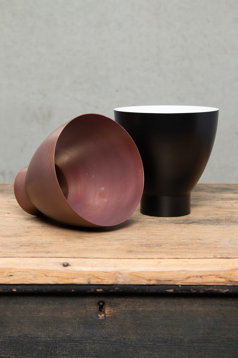 Celler shades in copper and steel wih a black finish. 