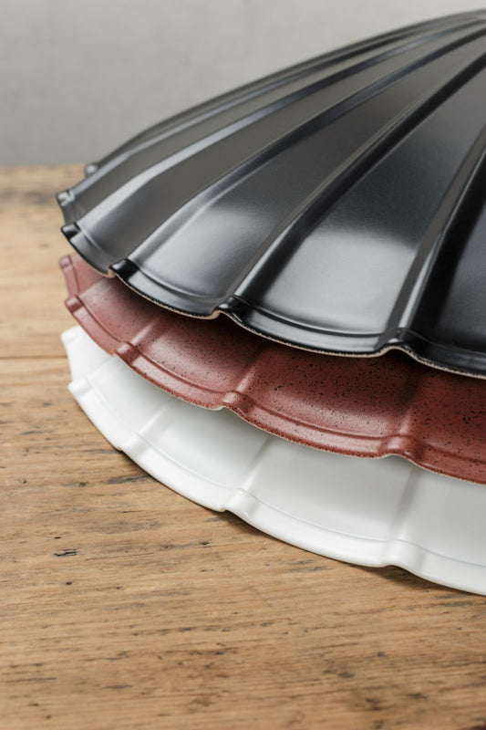 Stack of vintage Umbrella steel shades in black, rust and white