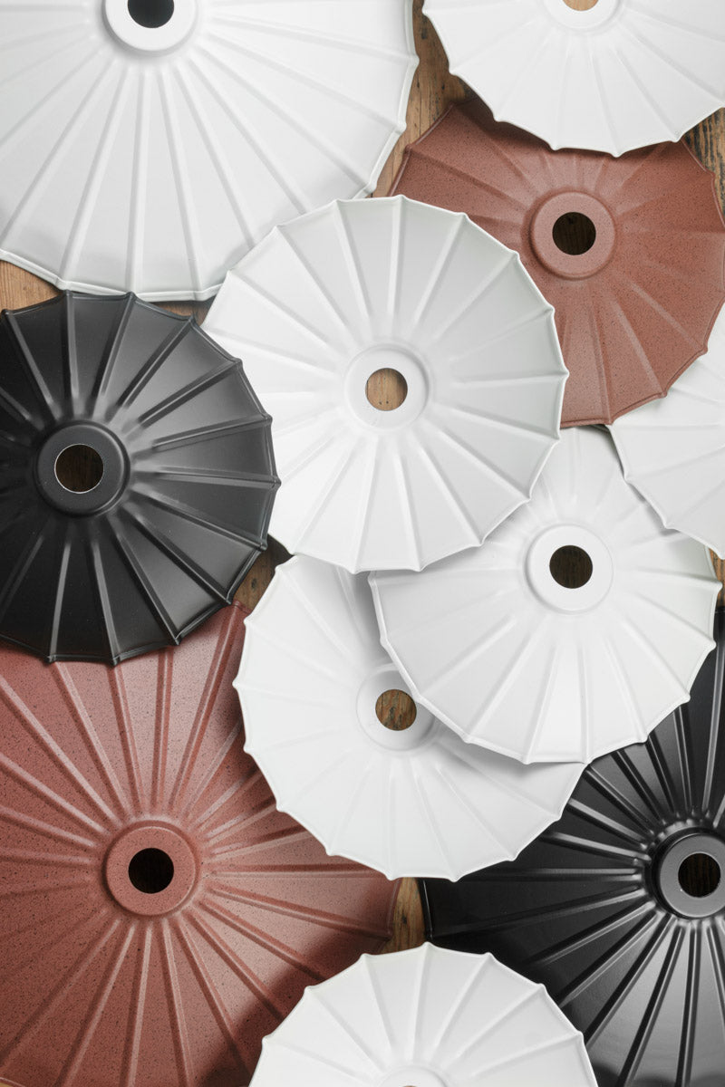 Umbrella shades in rust, white and black finishes