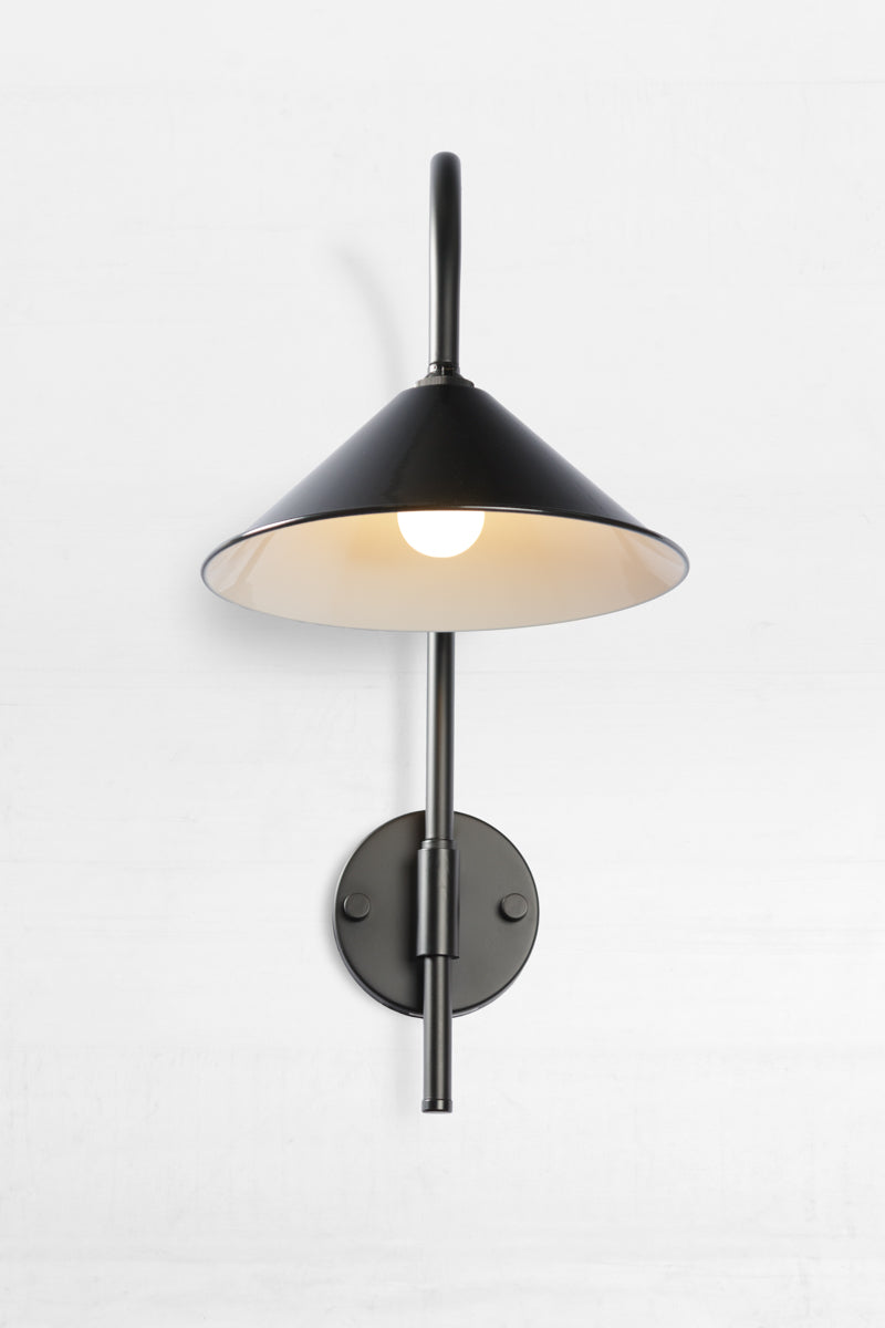 Front view of the Shepard gooseneck wall light in black with a black cone shade. 