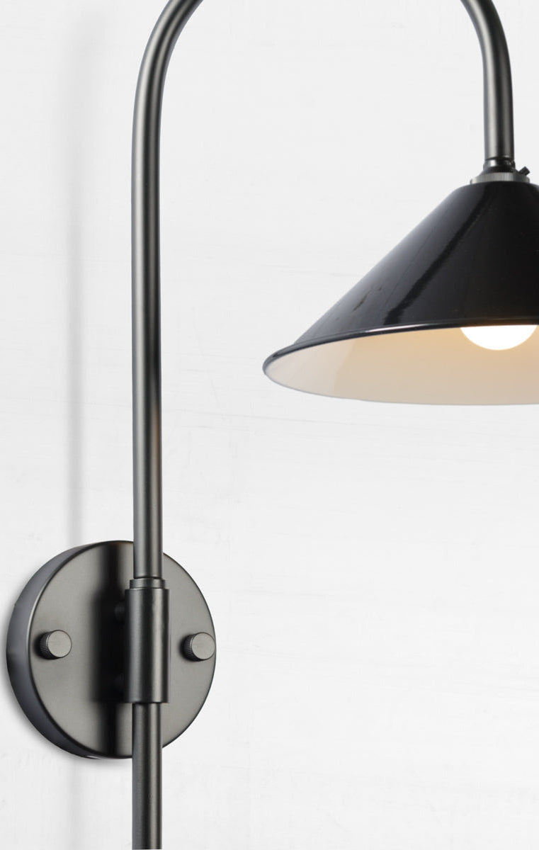 Close up of the Shepard gooseneck wall light in black with a black cone shade. 