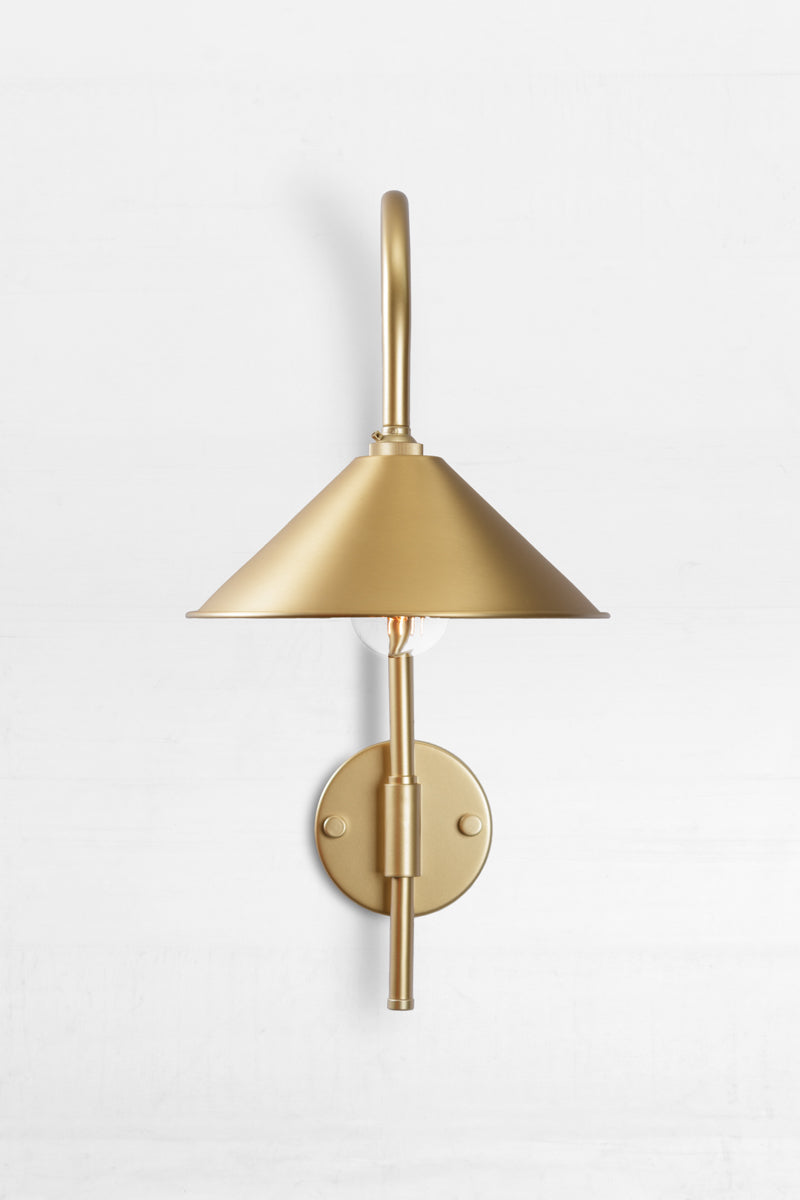 Front view of the Shepard gooseneck wall light in gold/brass with a solid brass cone shade. 