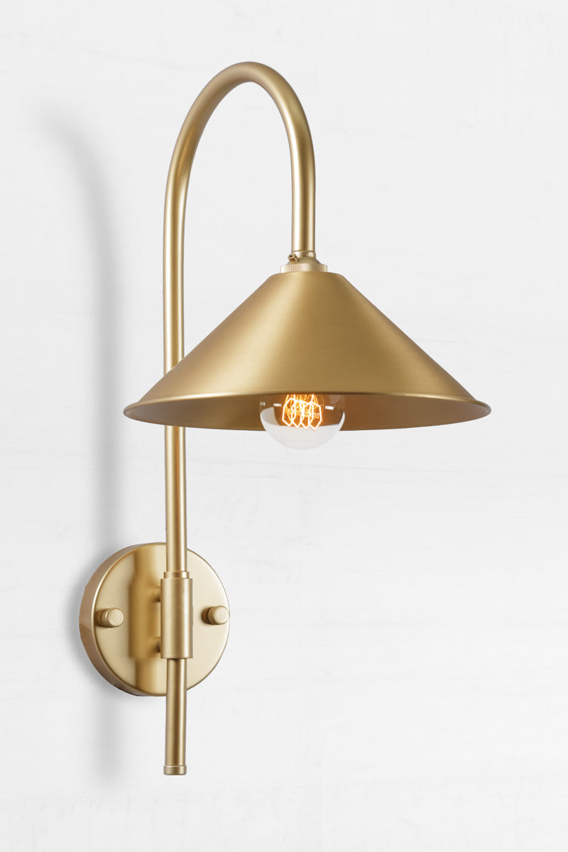 Shepard gooseneck wall light in gold/brass with a solid brass cone shade. 