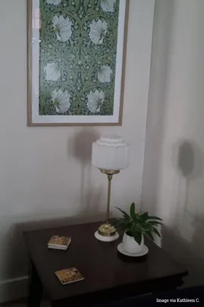 Deco lamp in gold/brass on a side table of a customers home. 