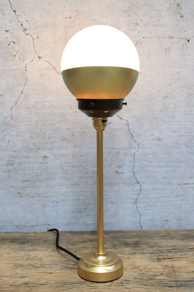 Crown Sphere Table Lamp with a gold lamp holder, black gallery and a gold and opal shade