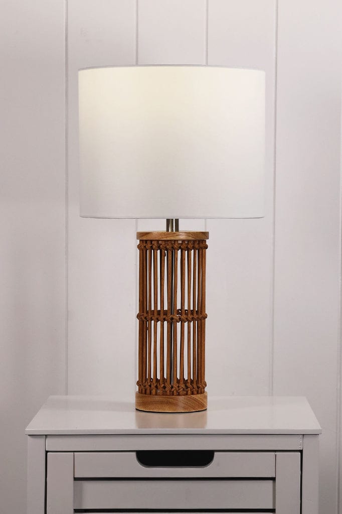 Bamboo table lamp with white shade on a table