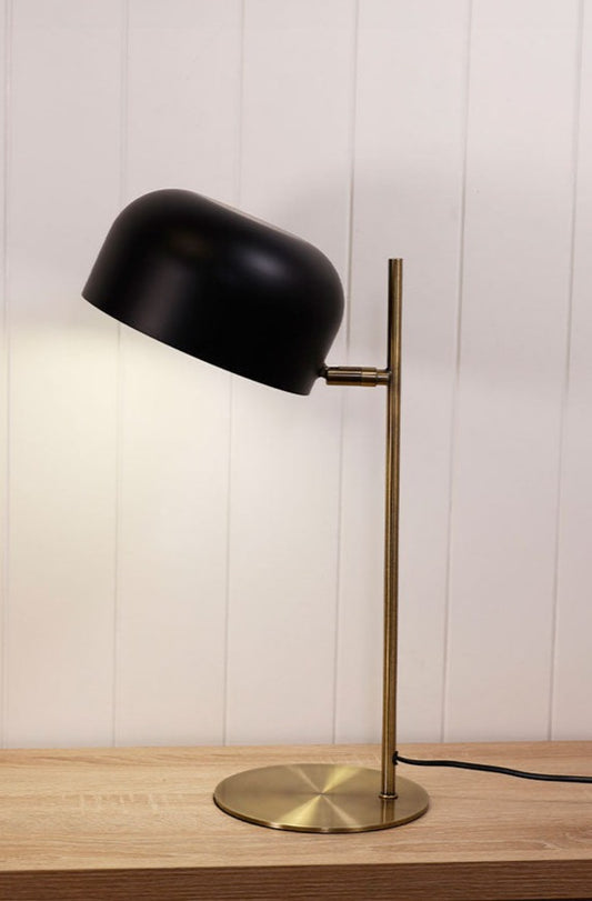 Table lamp with brass finish and black shade