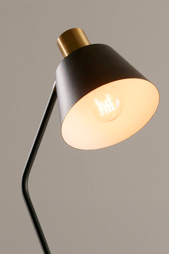 Close-up view of the Cine Table Lamp's on a beige background.