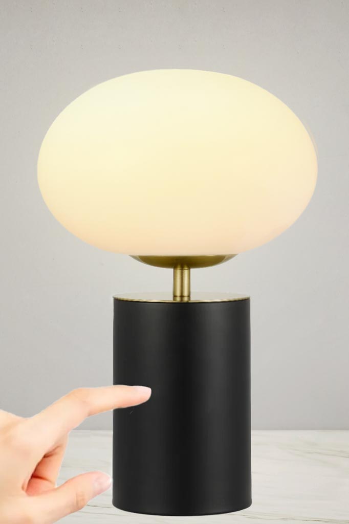 Illuminated Bogart Touch Table Lamp with a black base.