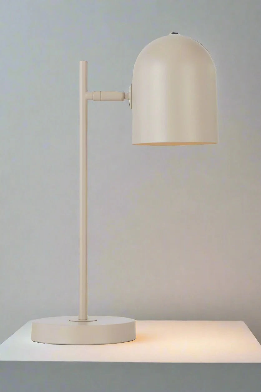 Khaki table lamp with adjustable head on a side table.