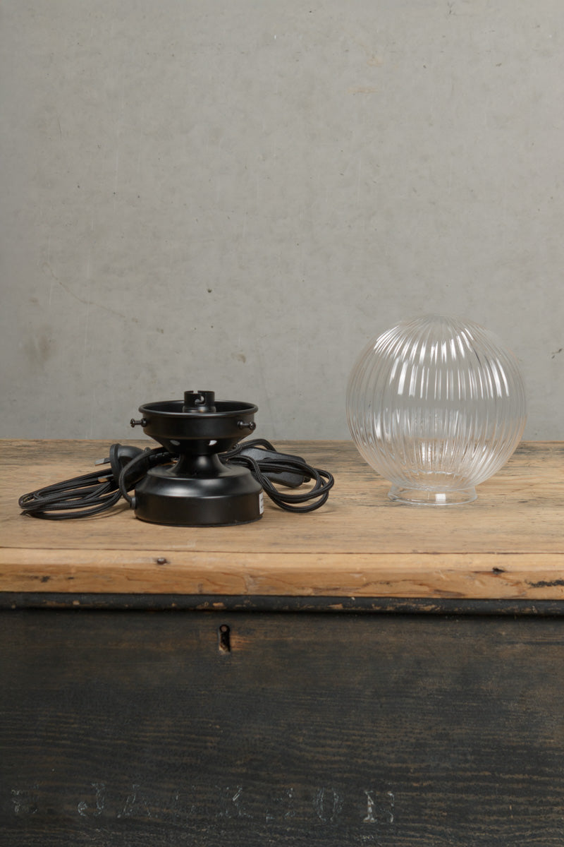 Components of the dakota clear reeded glass lamp and black base. 