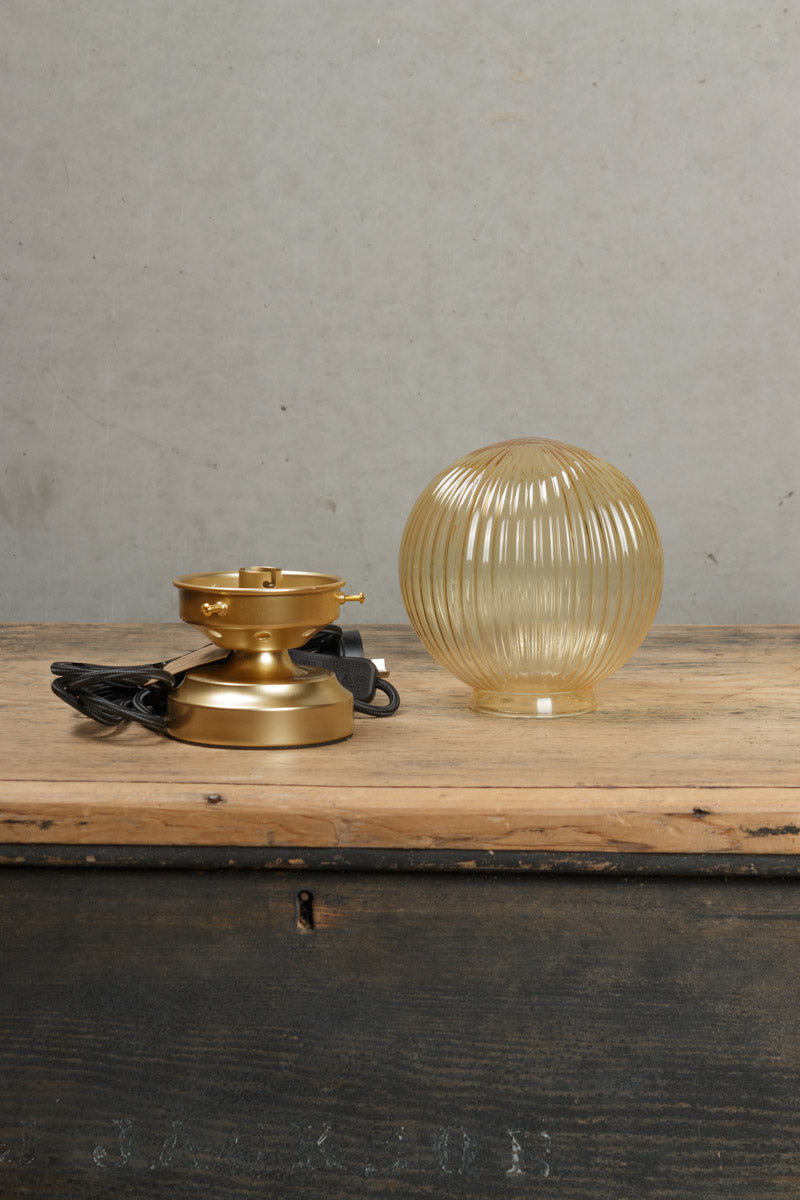 Components of the dakota amber reeded glass lamp and gold/brass base. 