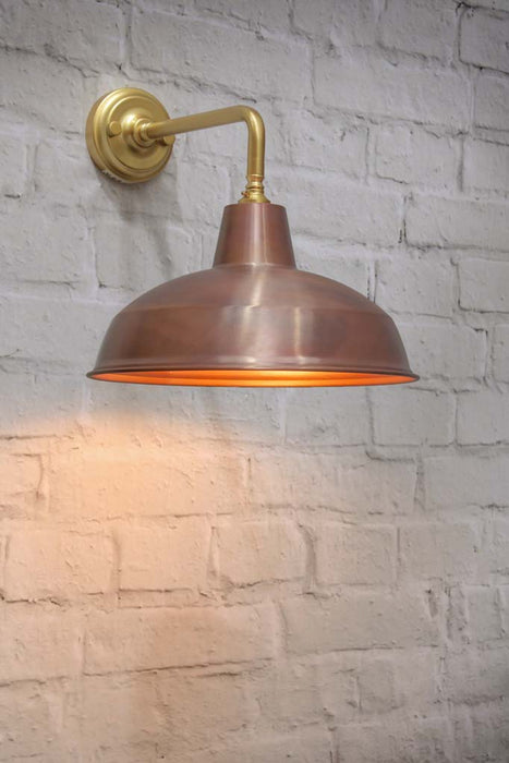 Aged solid copper warehouse shade on a gold/brass steel sconce.