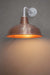 Aged solid copper warehouse shade on a white steel sconce.