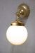 Small opal glass ball shade on a gold/brass wall sconce