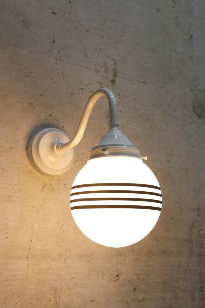 Hand painted opal glass ball pendant light with four stripes on white steel sconce.