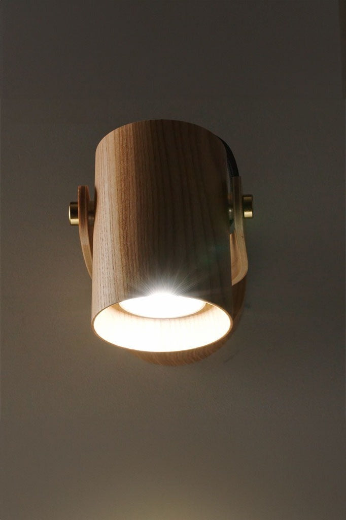 Side perspective of Wood Cylindrical Wall Lamp highlighting its design.