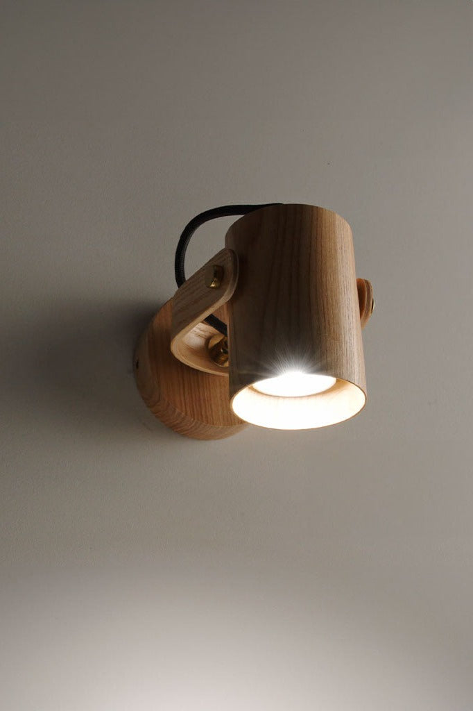 Angled view of the sleek Wood Cylindrical Wall Lamp.