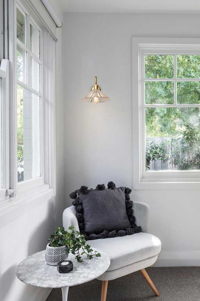 Paris Pleated Glass Gooseneck Gold Wall Light in a reading room.