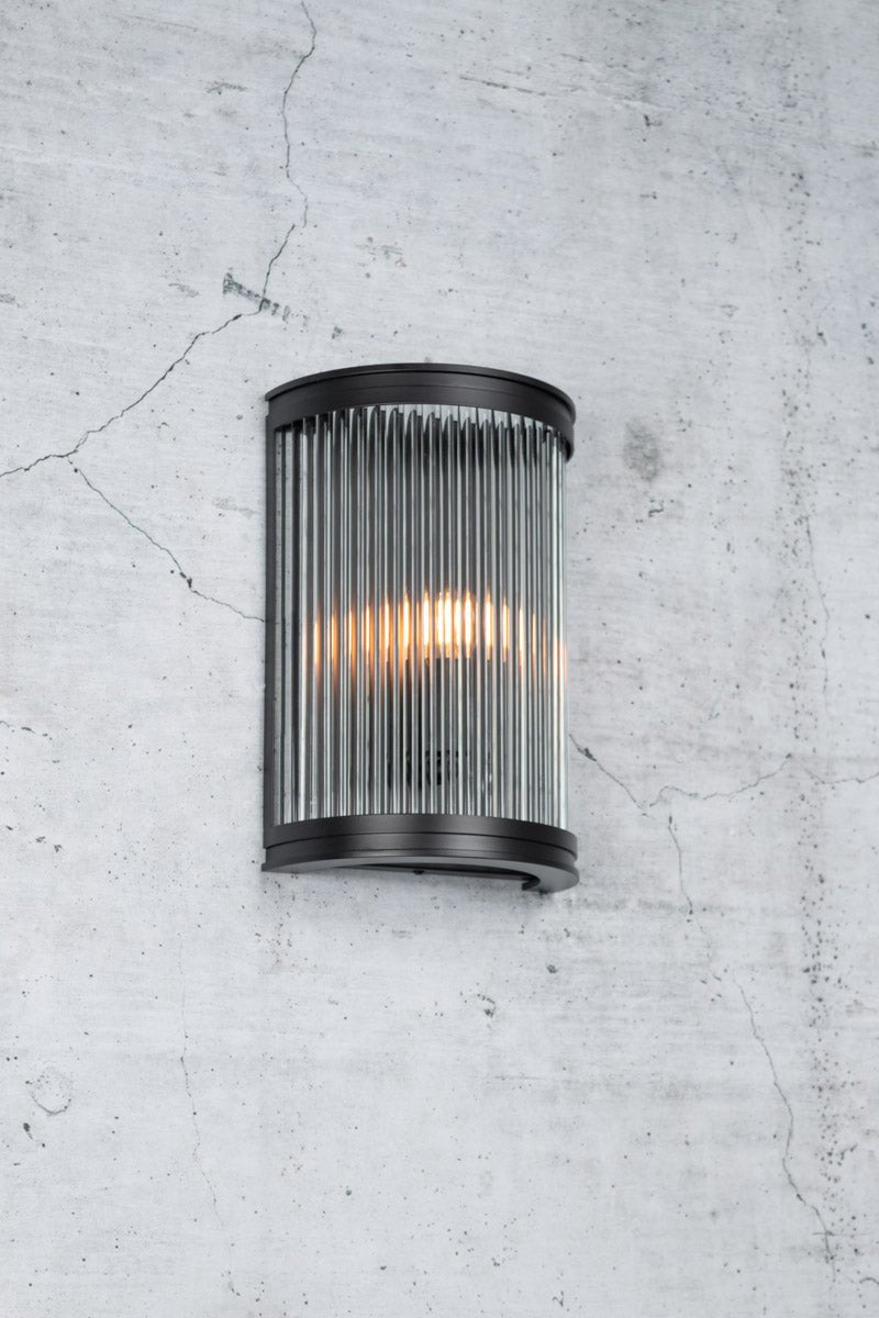 Classic modern wall light with curved black steel shade and glass rods