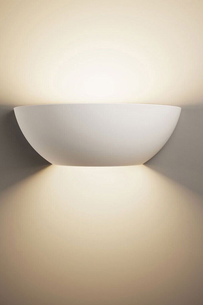 Illuminated dish shaped plaster wall light.