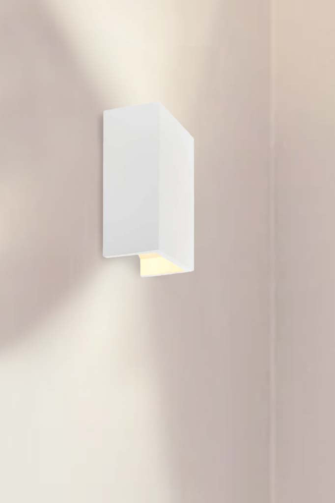 Illuminated open ended rectangular plaster wall light.