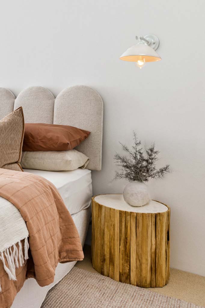 White Bakelite Wall Light white arm being used as a bedside table light.