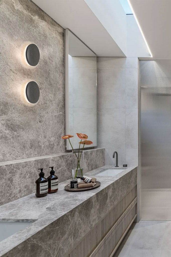 Grey circle wall lighs in a modern bathroom.