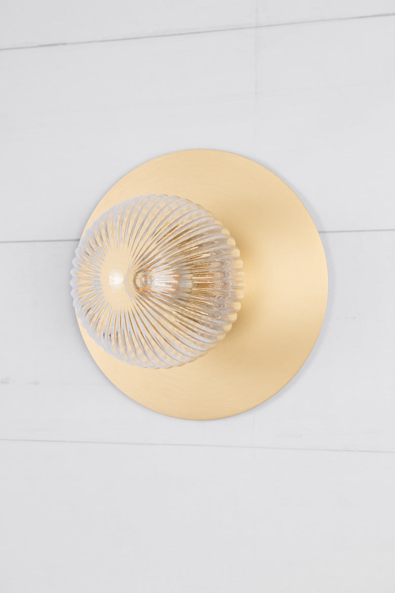 Small clear reeded glass ball shade n a large brass disc. 