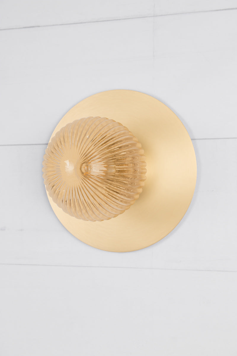 Small amber reeded glass ball shade n a large brass disc. 