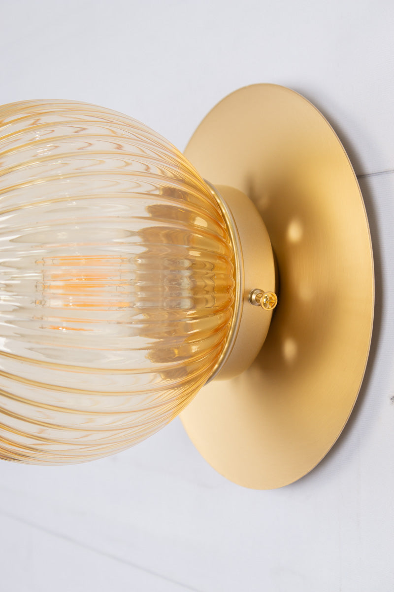 Small amber reeded glass ball shade n a small brass disc. 