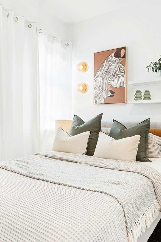 Reeded clear glass ball lights with brass disc detail in a bedroom. 