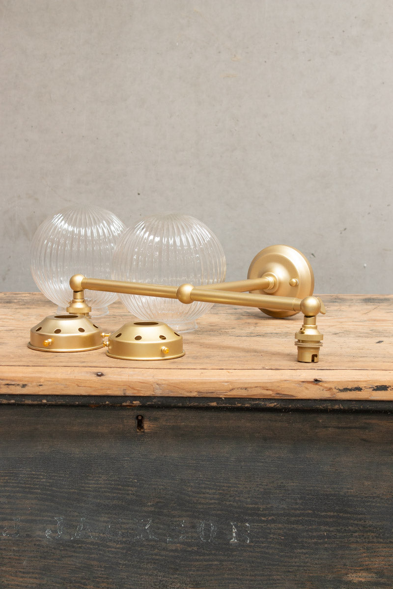 clear glass shades with gold brass arm sconce