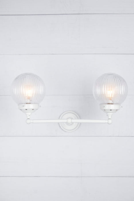 clear shades on white arm sconce