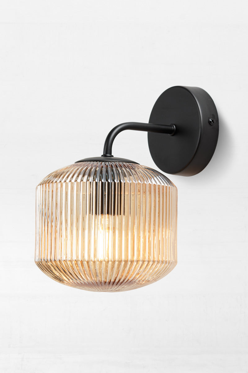 Steller Reeded Glass Wall Light amber shade and black wall sconce