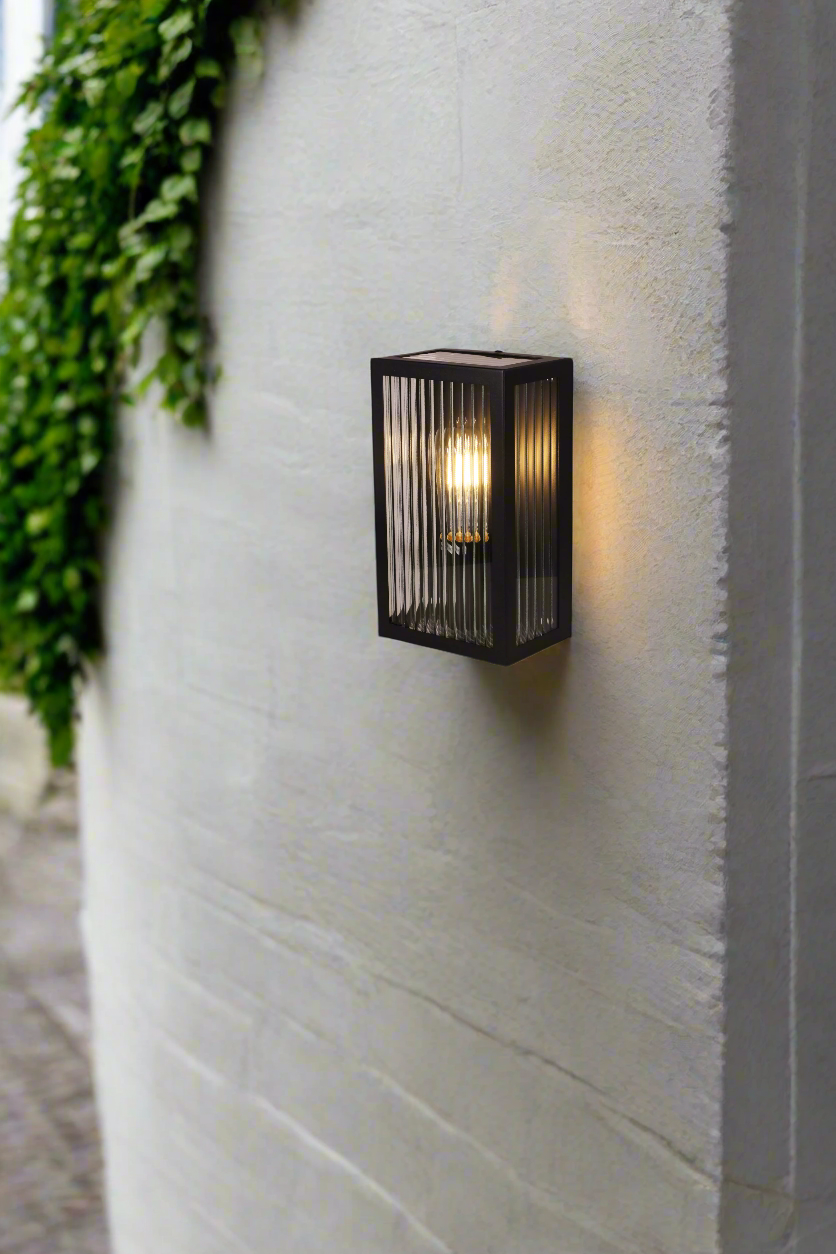 Black framed reeded glass wall light