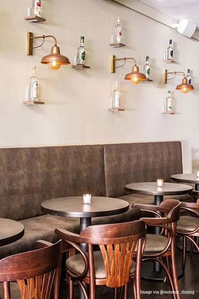 Copper railway wall lights along the dining space of ouzobar_dining